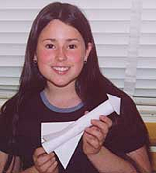 A picture of a girl holding a paper rocket