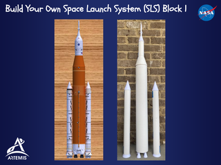 A model of the Space Launch System (SLS) rocket and a homemade paper model of the SLS rocket