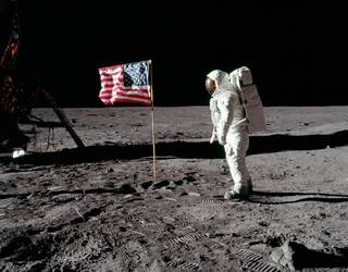 Astronaut Buzz Aldrin stands on the Moon facing a U.S. flag during the Apollo 11 mission in July 1969.