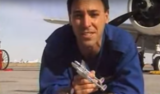 A pilot holds a small model airplane