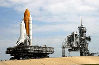 A photo of a space shuttle sitting on a crawler