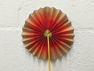 A paper fan colored to look like Earth’s layers
