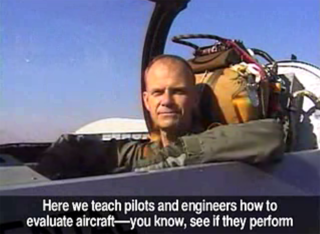 A pilot sits in the cockpit of a jet