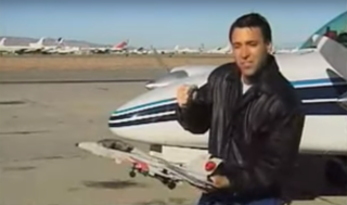 A pilot holds a model airplane