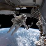 NASA astronaut Drew Feustel is pictured tethered to the International Space Station just outside of the Quest airlock during a spacewalk he conducted with fellow NASA astronaut Ricky Arnold (out of frame) on June 14, 2018. During the six-hour, 49-minute spacewalk the duo installed high-definition cameras to provide enhanced views of commercial crew spacecraft, including the SpaceX Crew Dragon and the Boeing Starliner, as they approach and dock with the orbital laboratory.