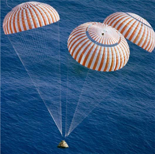 An Apollo Command Module nears splashdown in the  South Pacific Ocean