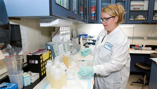 A scientist processing urine samples