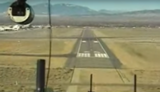 View of the runway as seen from the cockpit of a landing airplane