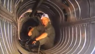 A test pilot sits in the bay of a jet engine