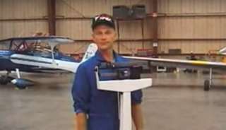 A test pilot stands on a weight scale