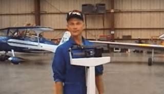 A test pilot stands on a weight scale