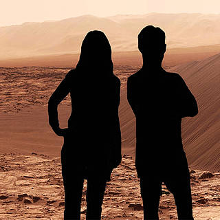 Silhouettes of two people in front of a Mars landscape