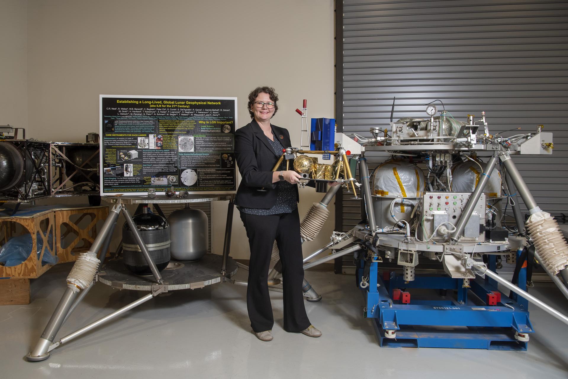 Pictured with lunar lander models, Renee Weber commemorating her recent transition to the MSFC Chief Scientist position.