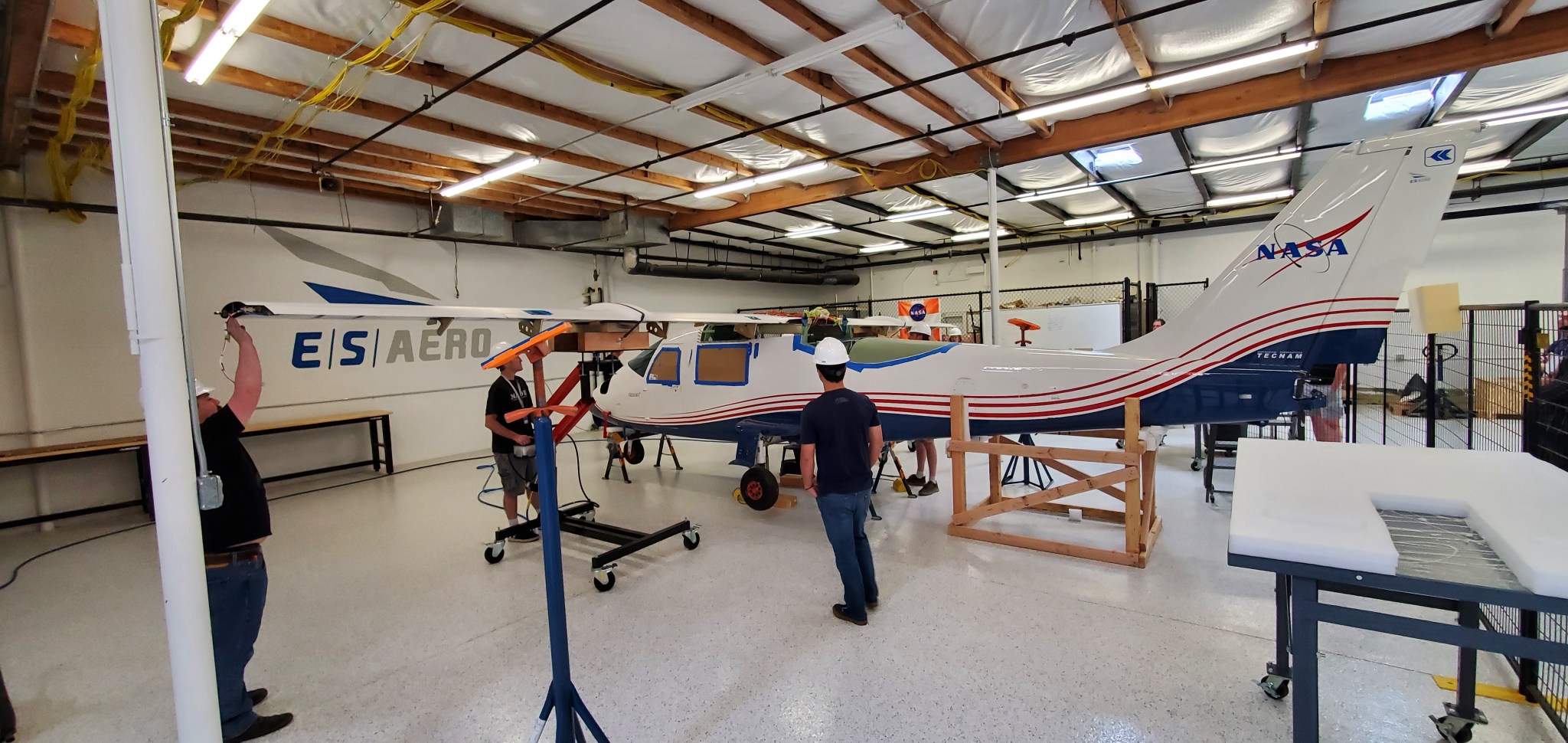 Engineers install the wings on NASA's X-57 plane.