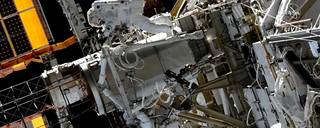 Spacewalkers Koichi Wakata (top) and Nicole Mann (bottom) work on the starboard truss structure to upgrade the space station’s power generation system.