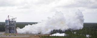 White smoke billows to the right of the photo as NASA conducts an RS-25 hot fire test on the Fred Haise Test Stand at NASA’s Stennis Space Center in south Mississippi on Feb. 22, 2023.