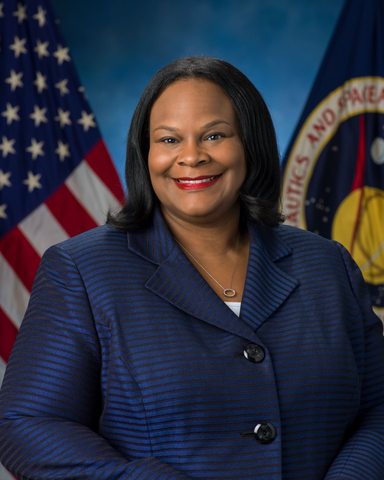 Portrait of Dawn L. Oliver, with U.S. and NASA Flags in background.