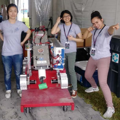 3 girls pose with a robot at the Lunabotics Women in STEM event