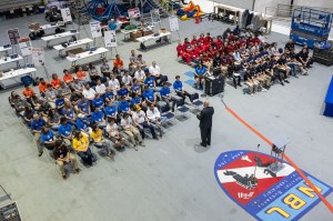 Large group of Micro-g NExT participants sit and listen to a speaker