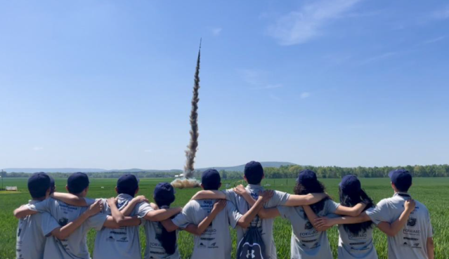 Student Launch teams watches their rocket take off.