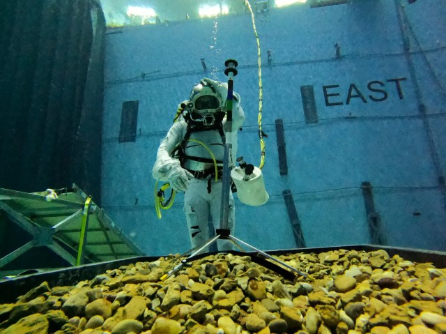 Underwater diver tests tool designed by students in the Micro-g Neutral Buoyancy Experiment Design Teams challenge.