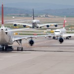 Commercial jets taxiing on and off the runway.