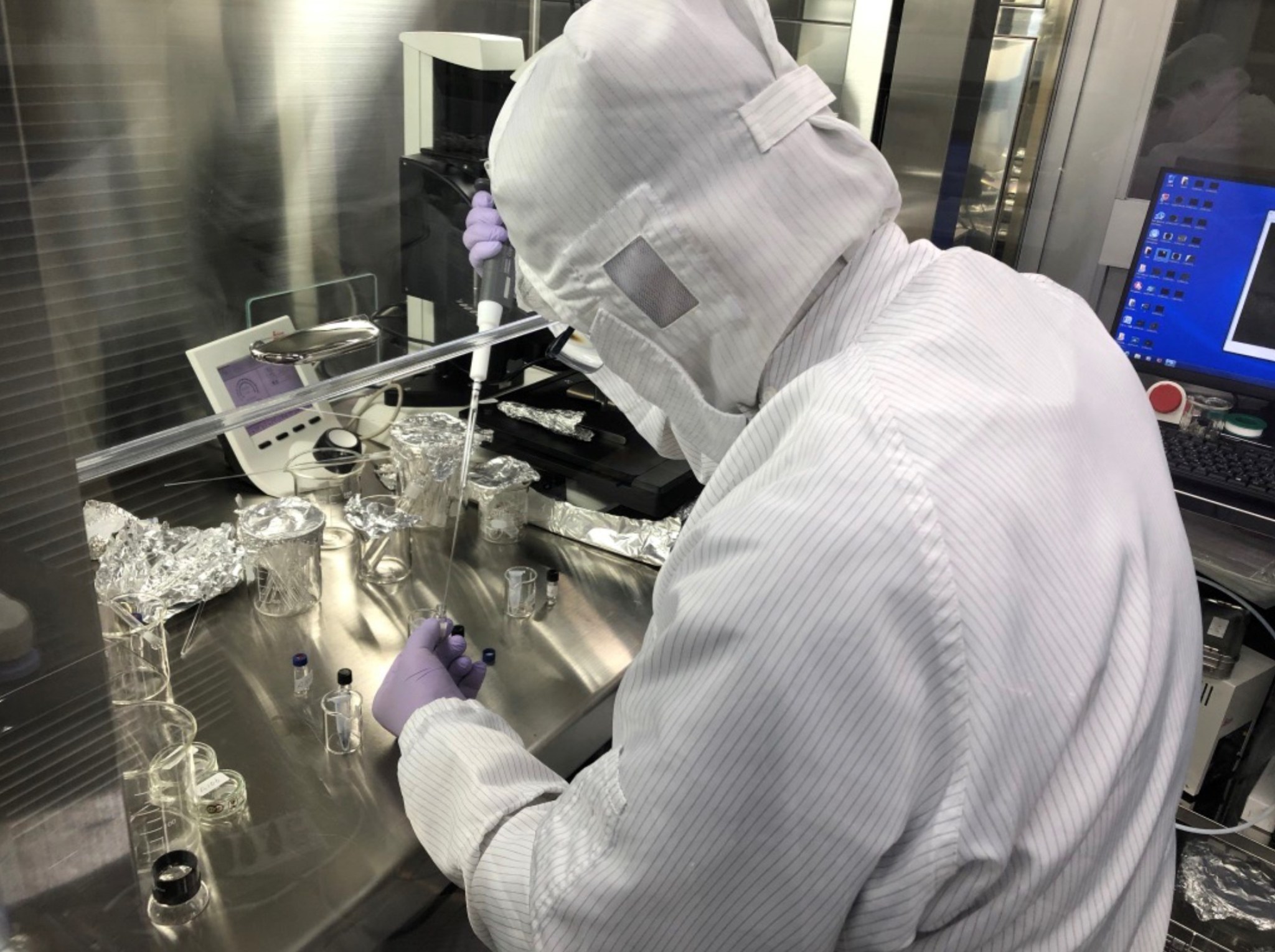 Image of scientist analyzing Ryugu sample.