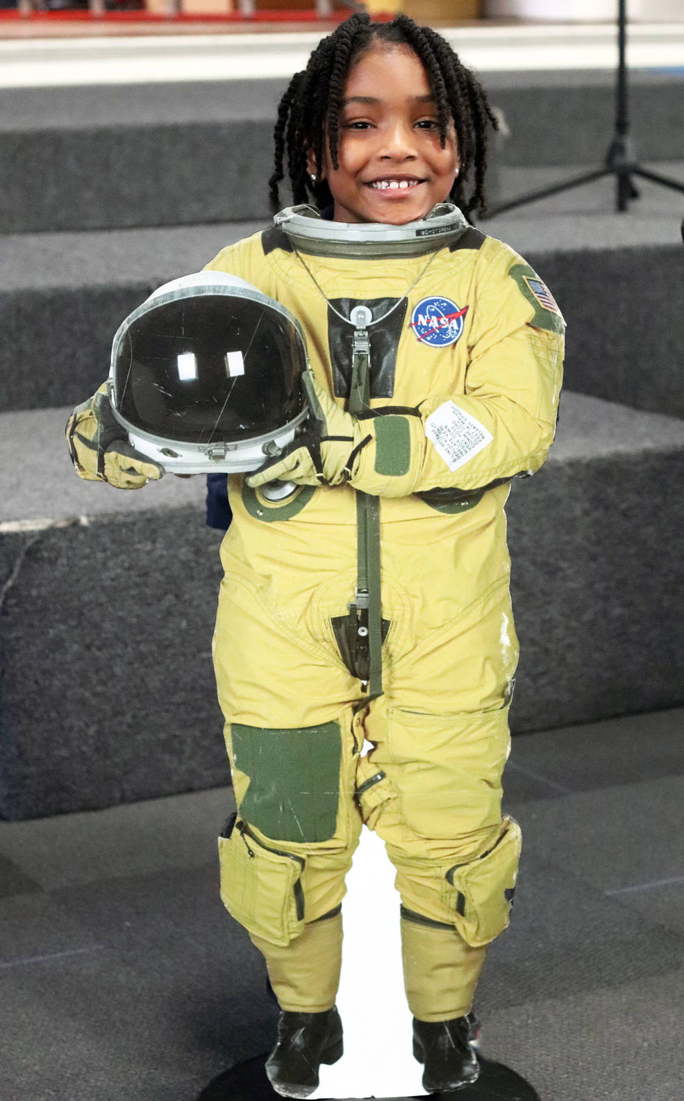 A student poses as an astronaut during an outreach event