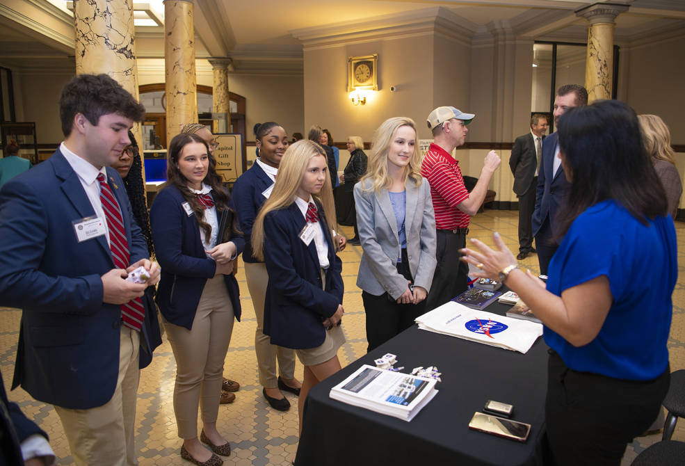 A group of students serving as legislative pages visit NASA's Stennis Space Center booth in the rotunda of the Mississippi State Capitol in Jackson, Mississippi, on Feb. 16 during 2023 Stennis Day at the Capitol activities.