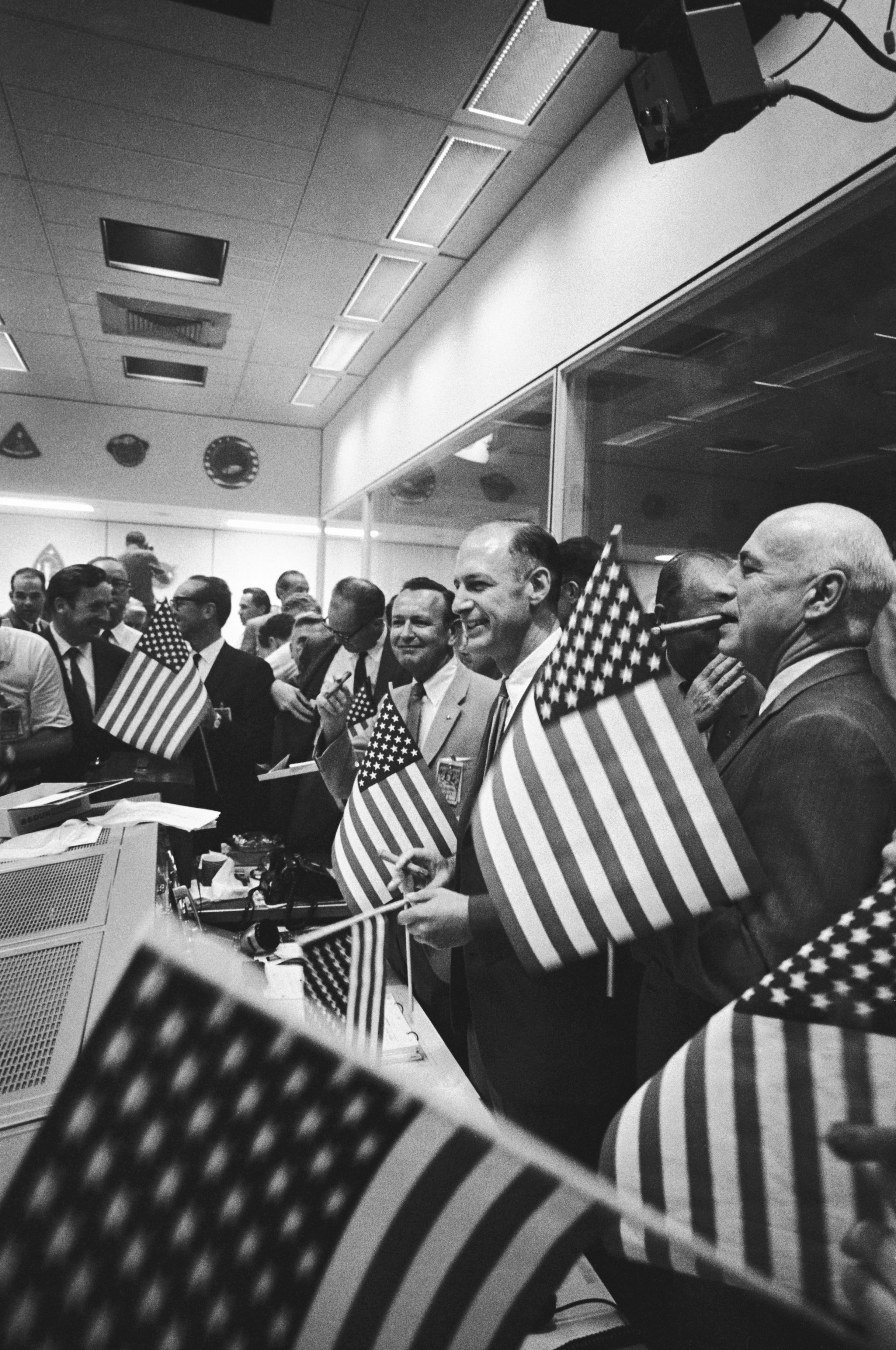 NASA and Manned Spacecraft Center (MSC, later renamed Johnson Space Center) officials join the Mission Operations Control Room flight controllers in celebrating the successful splashdown of the Apollo 11 crew. Identifiable in the foreground from right to center are MSC Director Bob Gilruth, Apollo Spacecraft Program Manager George Low, and MSC Director of Flight Operation Chris Kraft. (24 July 1969)