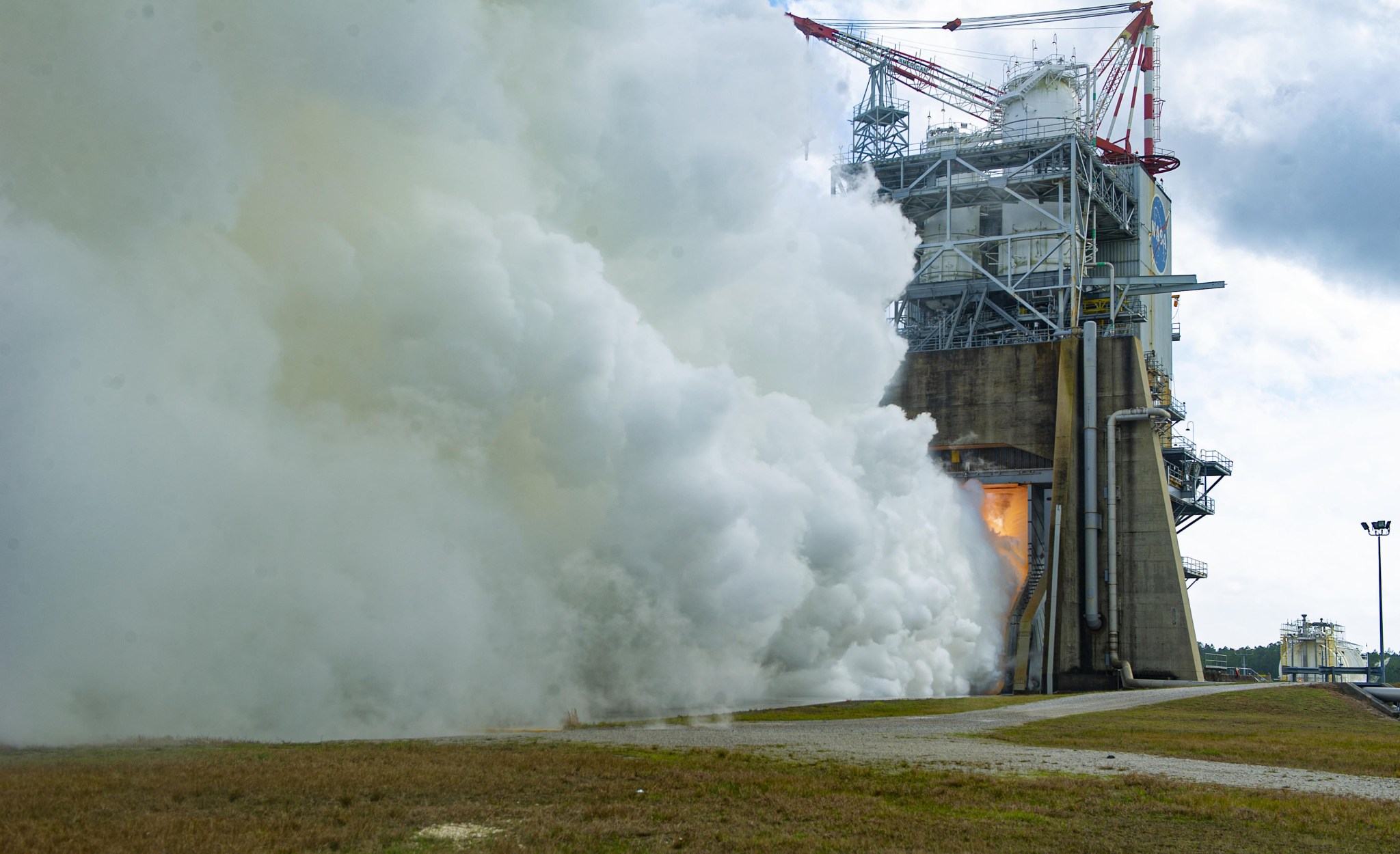 A mounted field camera offers a close-up views as NASA conducts an RS-25 hot fire test on the Fred Haise Test Stand.