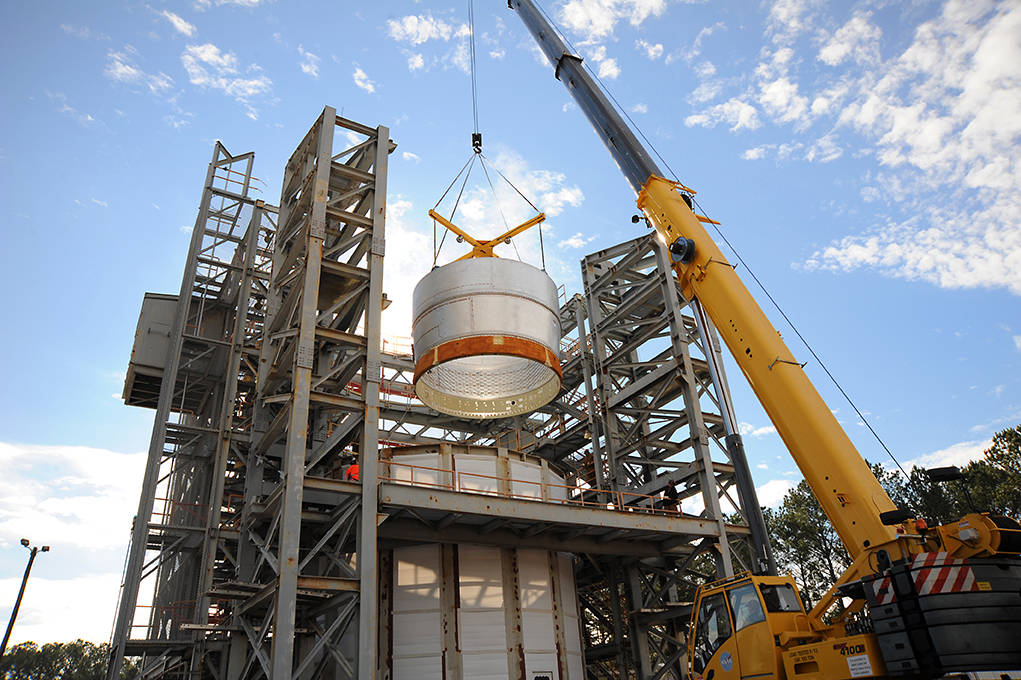 The test article stage adapter is lowered into a test stand in the East Test Area at NASA's Marshall Space Flight Center.