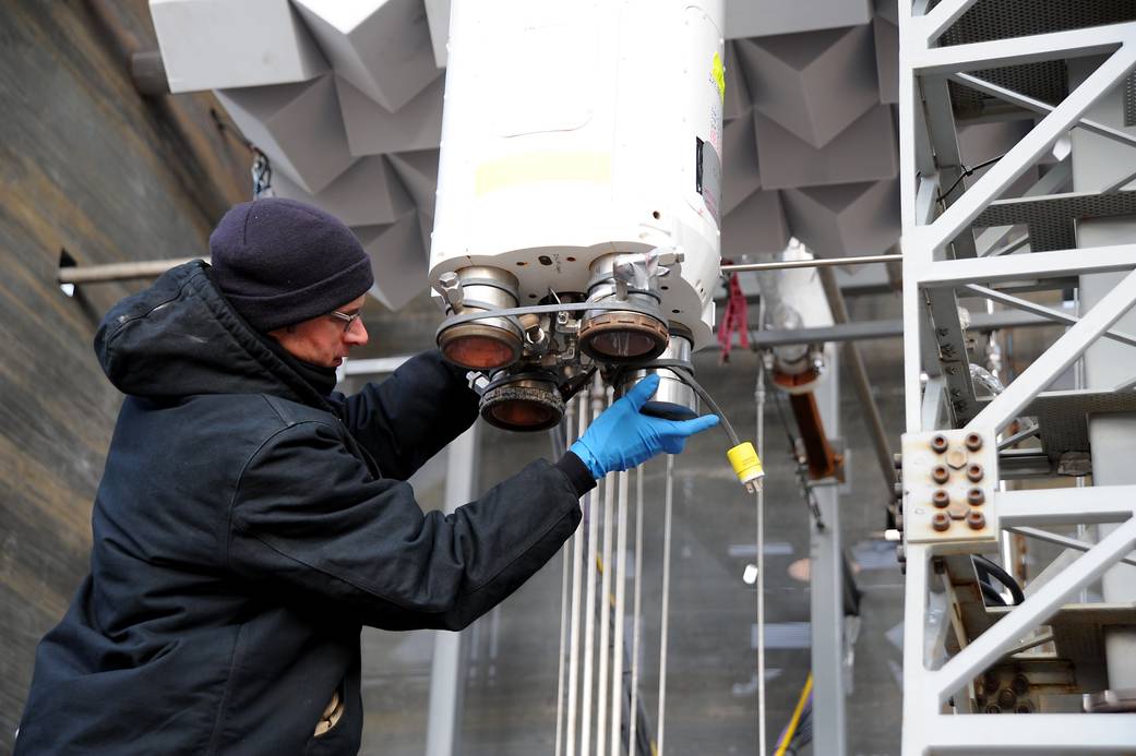 Michael Martin installs a leak check fixture on one of the liquid oxygen/hydrogen thrusters ahead of testing on the scale model.