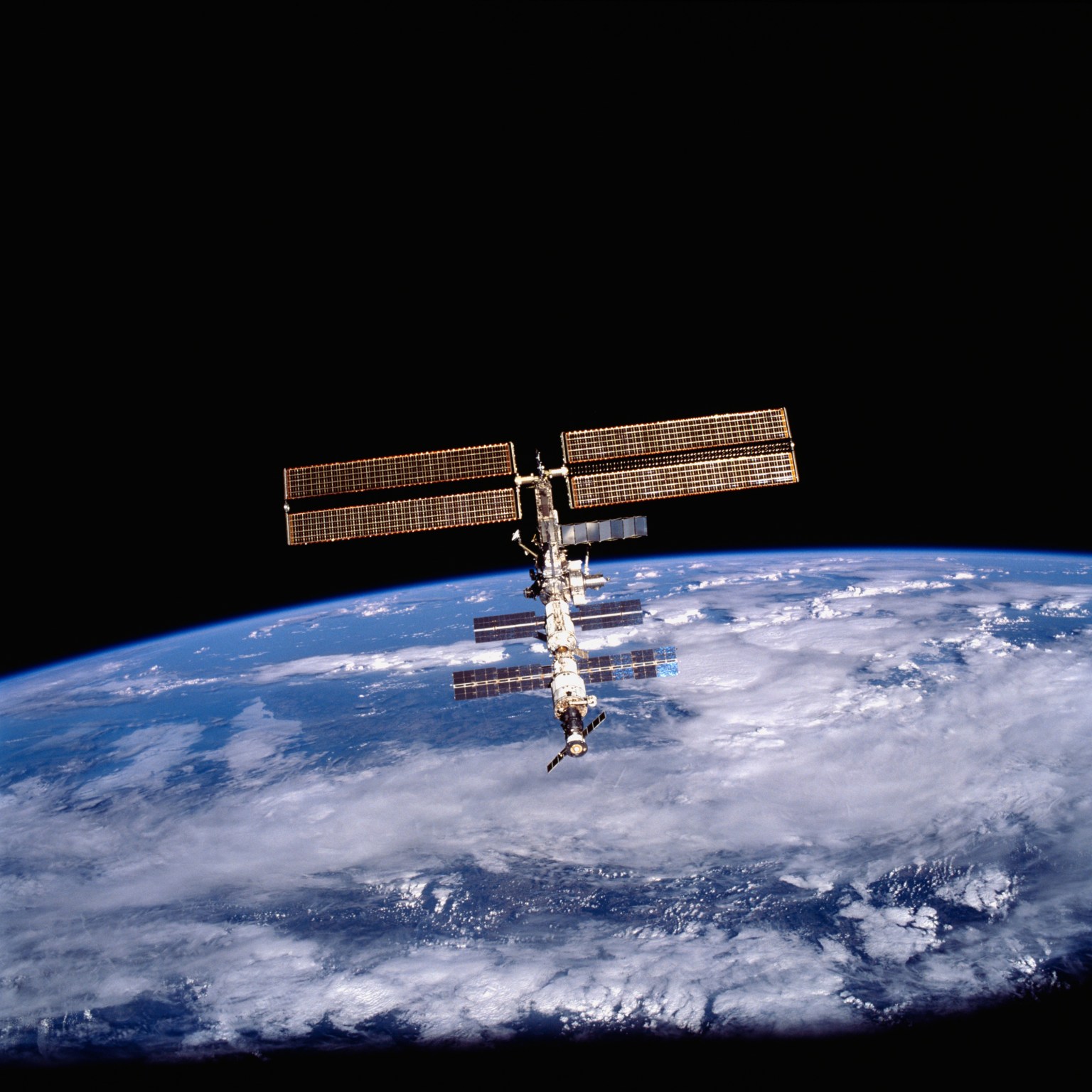 The International Space Station as seen from a Space Shuttle in 2001 with the Earth in the background.