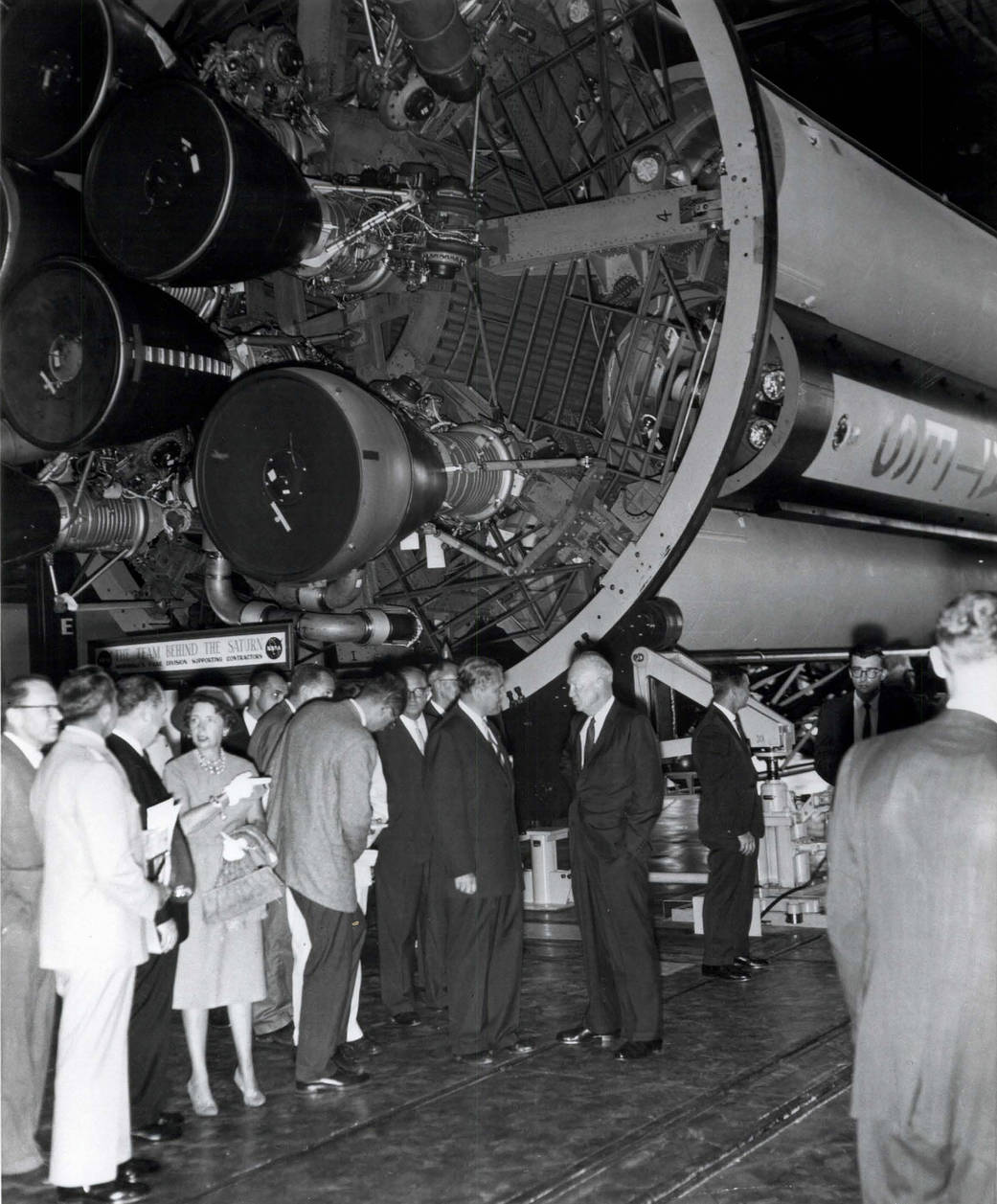 Eisenhower talks with Wernher von Braun, Marshall's first center director, in front of the core stage of a Saturn I rocket.