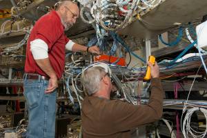 From left, Wayne Arrington and Steve Presti install Developmental Flight Instrumentation Data Acquisition Units.