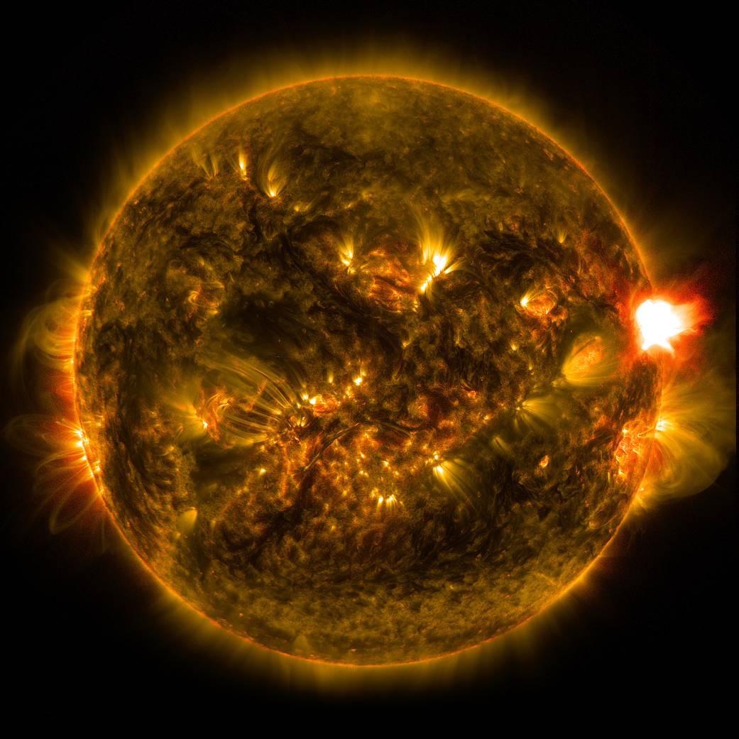 An M-class solar flare erupts from the right side of the sun in this image from shortly before midnight EST on Jan. 12, 2015. Th