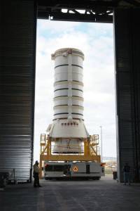aft skirt and lower segment of a Solid Rocket Booster (SRB) moving through doors