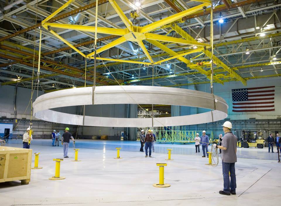 Technicians at NASA's Michoud Assembly Facility in New Orleans lower a qualification ring for the SLS core stage.