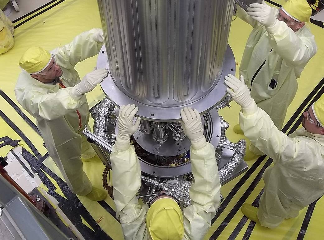 NASA & NNSA engineers lower the wall of the vacuum chamber around the Kilowatt Reactor Using Stirling TechnologY (KRUSTY system)