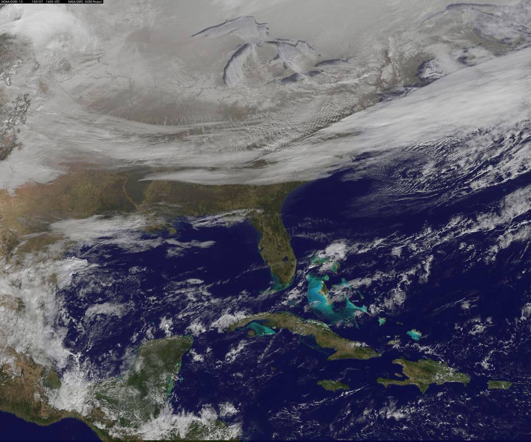 A blanket of northern snow, lake-effect snow from the Great Lakes and clouds behind the Arctic cold front.