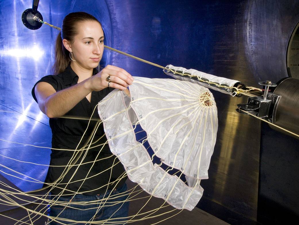 Glenn engineer Christine Pastor is showing an unpacked flexible canopy in NASA Glenn's 10x10 Supersonic Wind Tunnel.