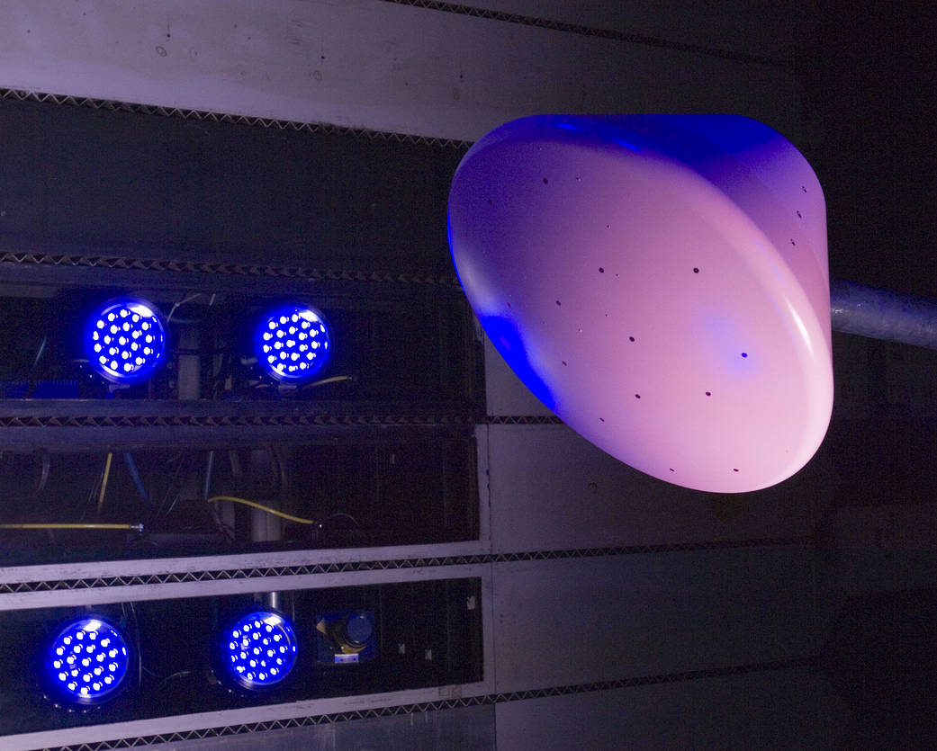 Blue-lit image of scale model of Crew Exploration Vehicle (CEV).