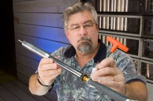 Test engineer Steve Buchholz adjusts the Crew Launch Vehicle (CLV) model.