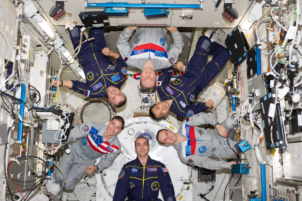 Expedition 38 crew members pose for an in-flight crew portrait in the Kibo laboratory of the International Space Station. 