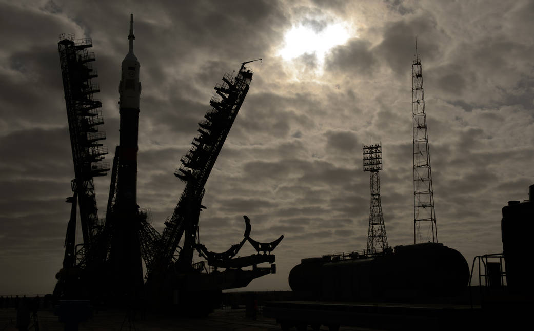 The gantry arms begin to close around the Soyuz TMA-12M spacecraft to secure the rocket at the launch pad on Sunday, March 23, 2