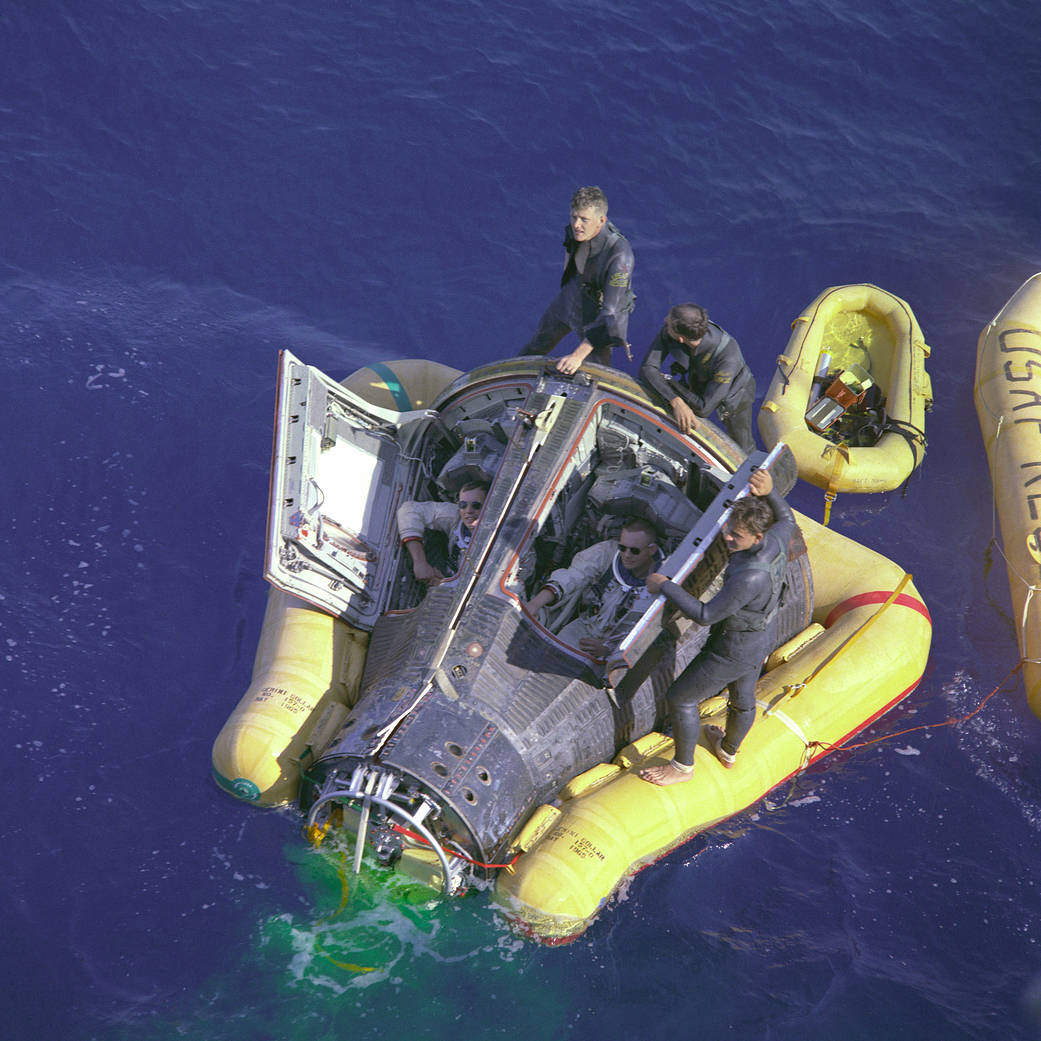 Pararescuers greet the Gemini 8 spacecraft in the Pacific Ocean
