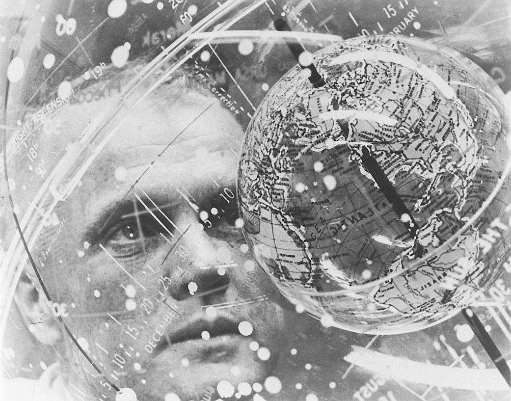 John Glenn looks into a globe during Gemini training, February, 1962