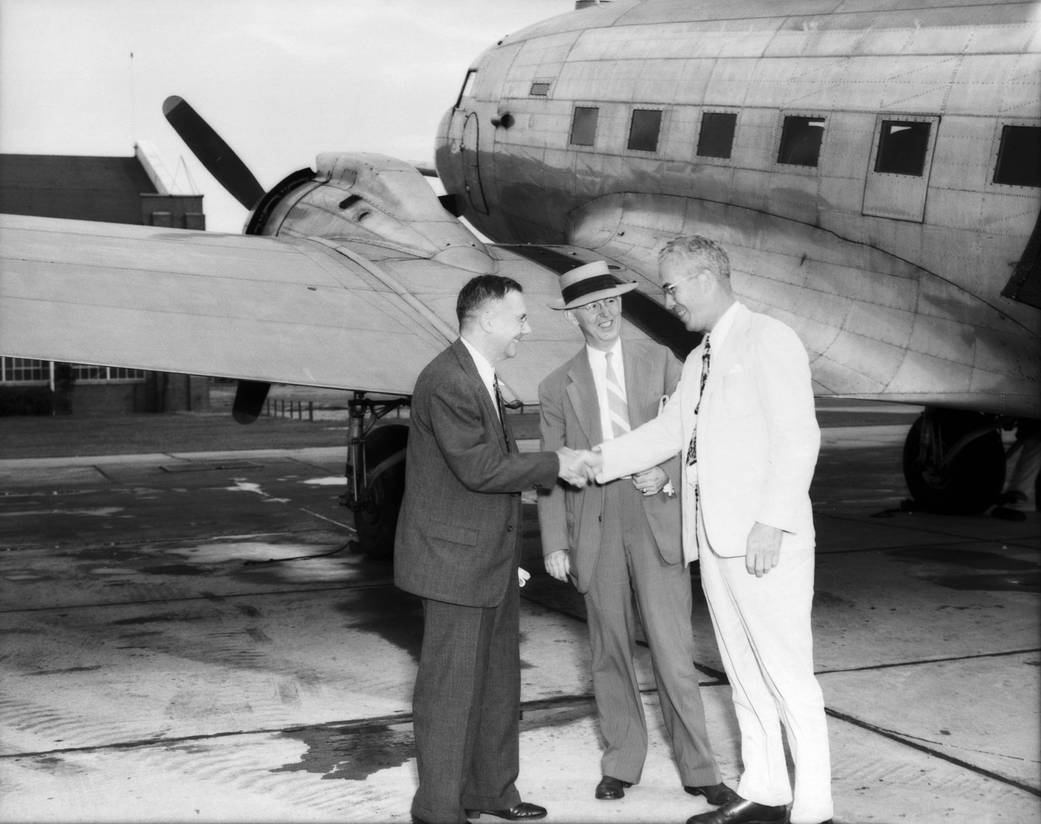 Hugh L. Dryden (left), arrives with John F. Victory, the NACA's executive secretary and is greeted by Henry Reid.