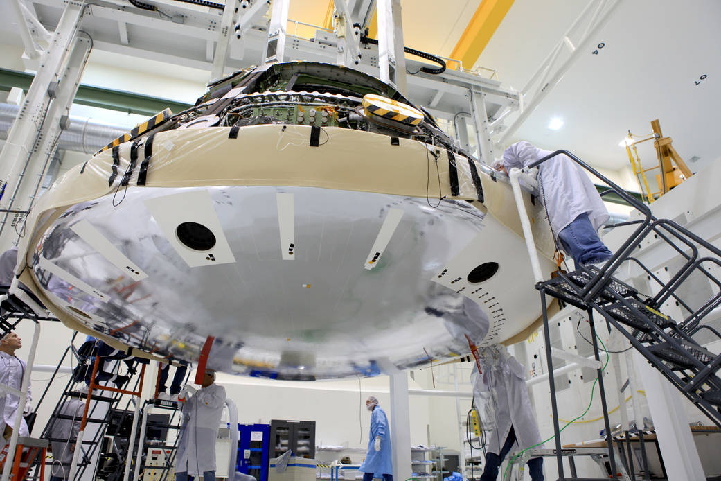 Orion spacecraft with heat shield suspended with bottom of spacecraft visible